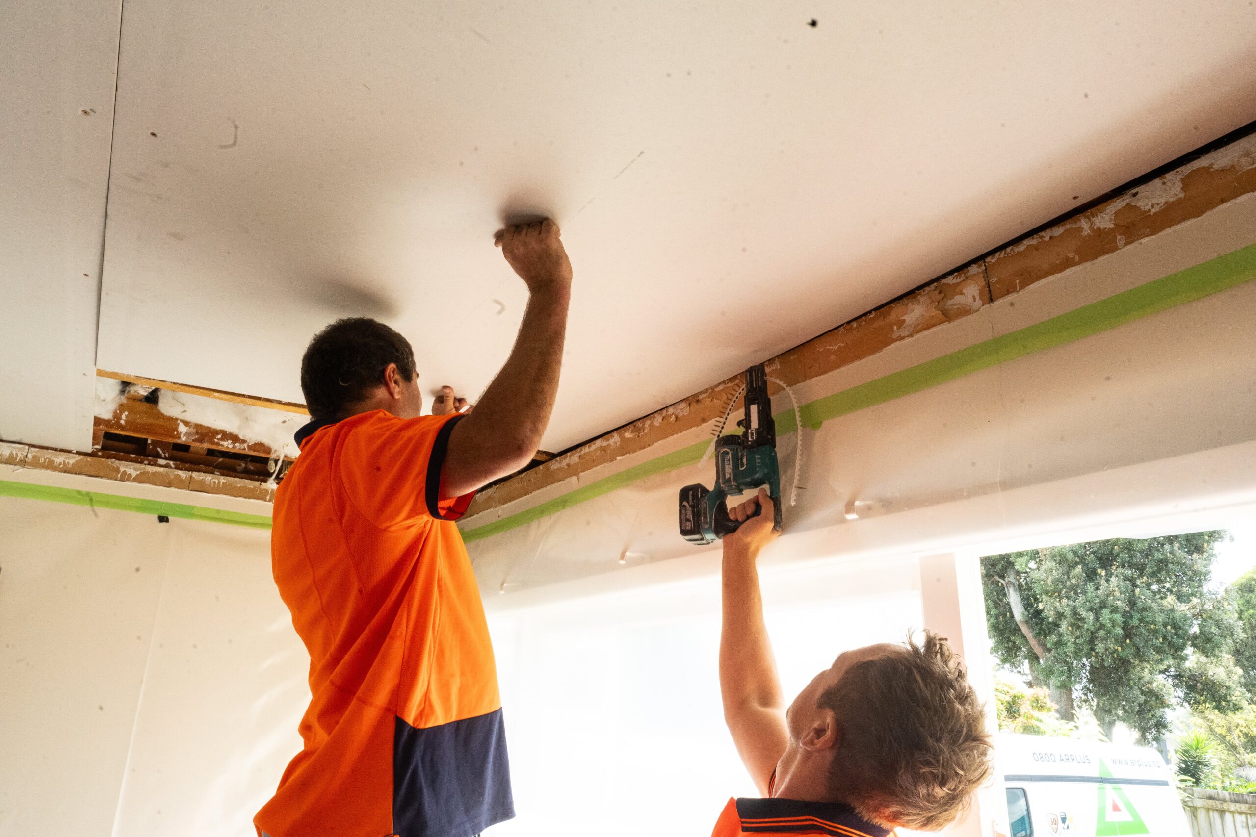 GIB plasterboard fixing being completed by two AR Plus team members