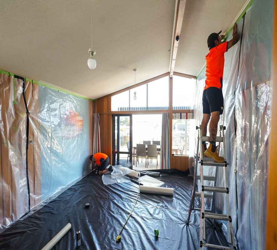 The interior of a house wrapped in plastic to prepare for painting and plastering. 