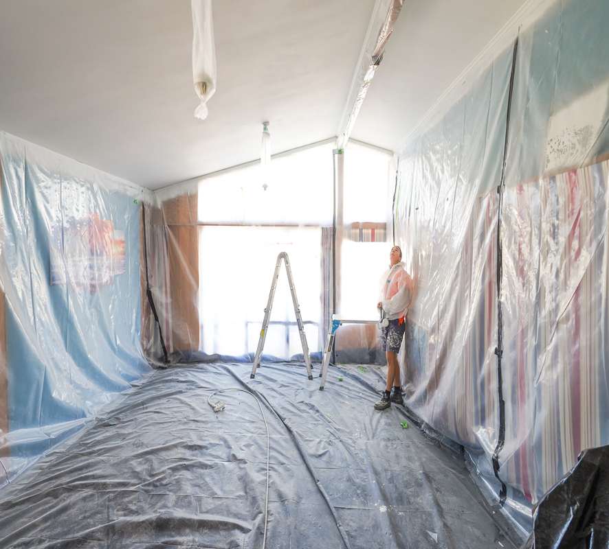 The interior of a house wrapped in plastic to prepare for painting and plastering. 