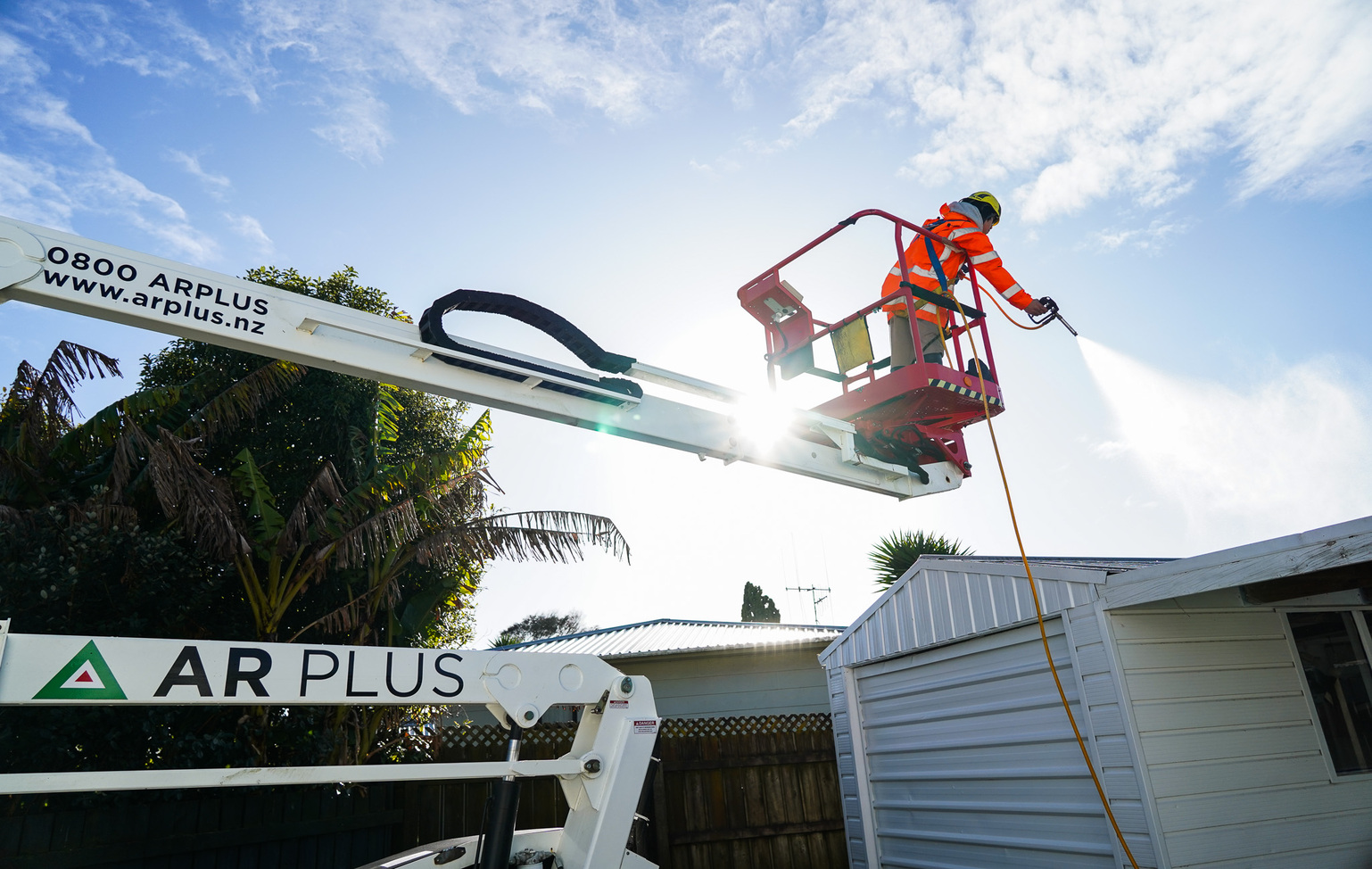 AR Plus moss and mould experts Tauranga clean a residential roof.